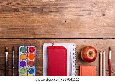 Desk With School Supplies. Studio Shot On Wooden Background. 