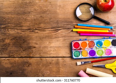 Desk With School Supplies. Studio Shot On Wooden Background. 