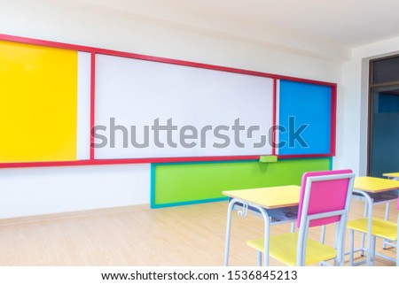 Desks, chairs and white board in the kindergarten classroom.