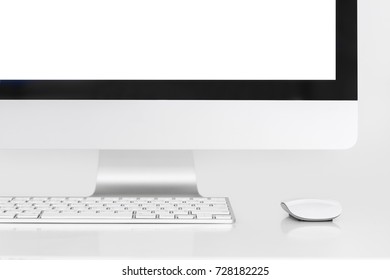 Desktop all-in-one computer with wireless mouse and keyboard on white background.