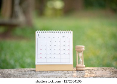 Desktop Calendar 2019 and hourglass place on office desk.Calender and diary for Planner, timetable,agenda,appointment,organization,management each date,month and year.Calendar Background Concept.