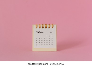 Desktop calendar for December 2022 on a pink background. - Shutterstock ID 2165751459