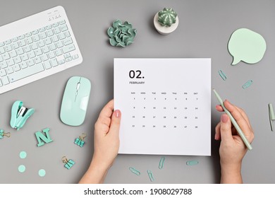 Desktop With Calendar For February And Office Supplies. Home Office, Social Media Blog, Schedule, Planning Concept. Flatlay, Top View