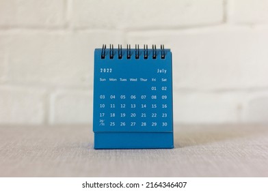 Desktop calendar for July 2022 on the table