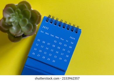 Desktop calendar for June 2022 on a yellow background
