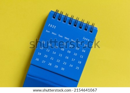 Desktop calendar for June 2022 on a yellow background