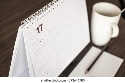 Desktop calendar sitting on desk showing year of 2017