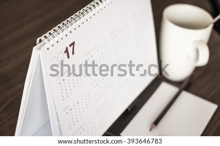 Desktop calendar sitting on desk showing year of 2017