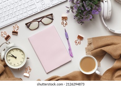 Desktop. Cashmere Scarf Glasses Of Alarm Clock Keyboard Note Pad Of Coffee Cups On The Table.