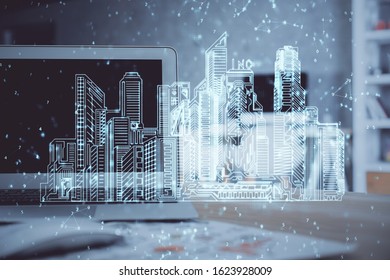 Desktop computer background in office and big town buildings hologram drawing. Double exposure. Smart city concept.