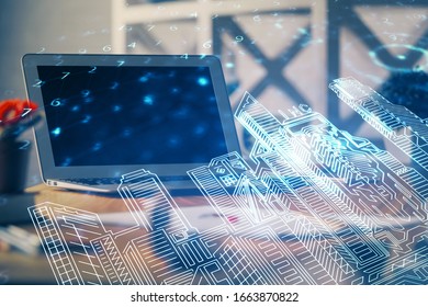 Desktop computer background in office and big town buildings hologram drawing. Double exposure. Smart city concept.