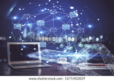 Desktop computer background in office and flying envelops hologram drawing. Multi exposure. Electronic mail concept.