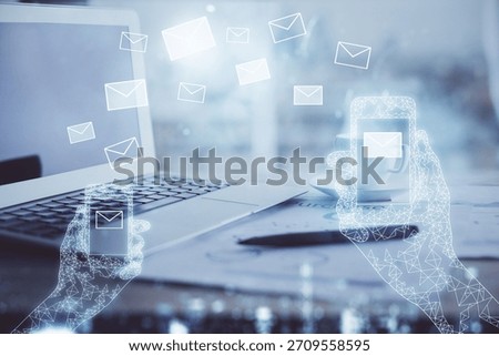 Desktop computer background in office and flying envelops hologram drawing. Double exposure. Electronic mail concept.