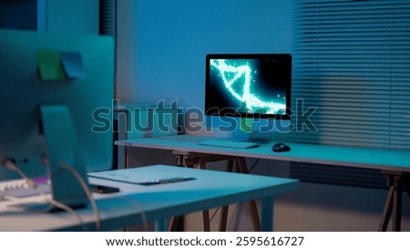 Desktop computer displaying rotating DNA double helix, illuminating darkened office space, representing cutting-edge genetic research and technological innovation during nocturnal working hours