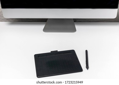 Desktop with desktop computer, graphic tablet for designer. Blank screen for mounting graphic display. Layout at the workplace.