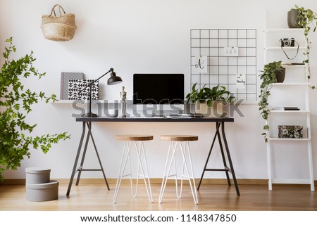 Desktop computer mock-up on an industrial desk in a scandinavian student bedroom interior workspace with white walls