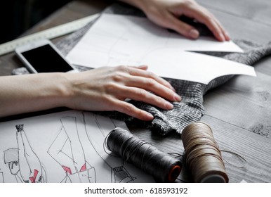 Desktop Designer Clothes With Tools At Wooden Table