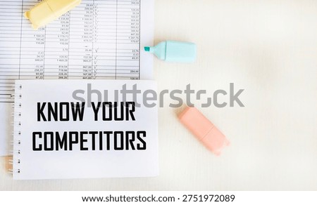 Desktop with documents, notepad with text Know Your Competitors