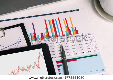 Desktop with documents, tablet and charts. Analytics of the company's activities. Budget planning, audit and tax calculation. The concept of issuing a loan and calculating salaries. Stock market.
