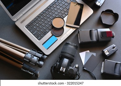 Desktop With Photography Equipment, Camera, Tripod,flash  And Computer