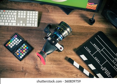 Desktop Shot Of A Modern Digital Cinema Camera And Clapboard On Stylish Wooden Desktop Workplace / Background - Flat Lay Shot