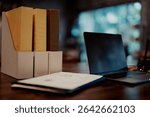 Desktop view with file holders, documents, and a laptop, representing structured office work and document management.