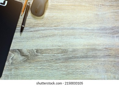 Desktop Wooden Pattern And Right Copy Space Have Pen Pensil Mouse Document File On The Lelt.