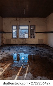 Desolate Abandoned Room with Puddle Reflection