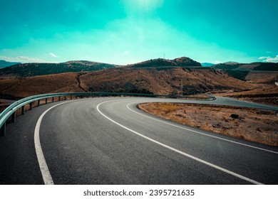 The desolate, empty and inviting highway stretching serpentine across the steppe. It is said that distance first accumulates inside a person, then it is only the road . Kars, Turkey.