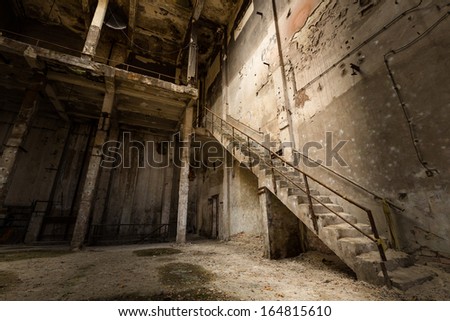 a desolate old industrial building inside, stair