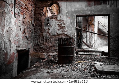 a desolate old industrial building inside, barrel