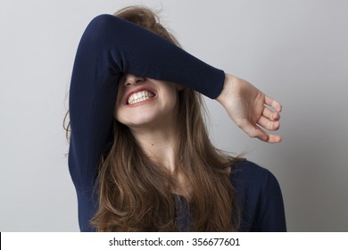 despair and anger concept - shocked young woman hiding her face with her arm,grinding teeth for dramatic resignation,studio shot
