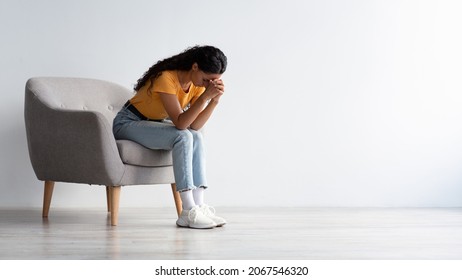 Despair Concept. Portrait Of Depressed Woman Sitting With Head Down In Armchair At Home, Lonely Young Lady Suffering Big Problems, Feeling Upset And Desperate, Panorama With Copy Space