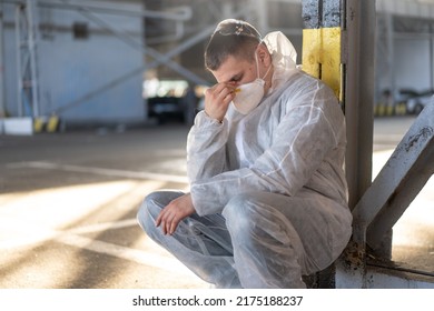 Despair Healthcare Worker In White Covid Protective Overalls.Tired Male Caucasian Doctor Grabs His Head Cower In Depression During Coronavirus Pandemic Paramedic Overworked Cry Covered Face With Hands