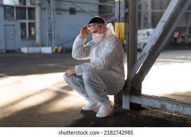 Despair Healthcare Worker In White Covid Protective Overalls.Tired Male Caucasian Doctor Grabs His Head Cower In Depression During Coronavirus Pandemic Paramedic Overworked Cry Covered Face With Hands