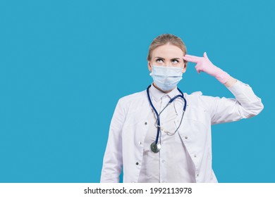 Despair And Powerlessness. Woman Doctor Shows A Gun With Two Fingers. Suicide Gesture. Refusal To Fight. The Futility Of Action.