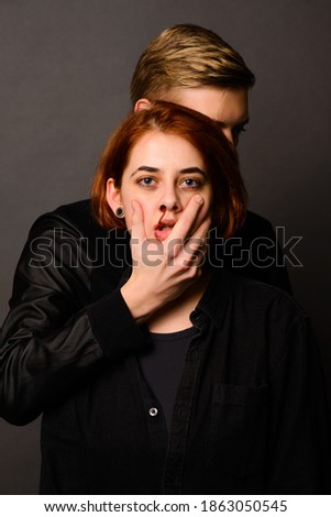 Young couple posing with funny faces