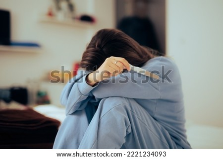 
Desperate Crying Young Woman Holding a Positive Pregnancy Test
Stressed girl feeling hopeless about her mother to be situation
