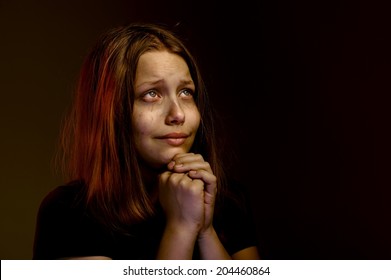 Desperate lonely teen girl praying
