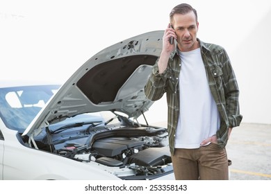 Desperate Man Calling For Assistance After Breaking Down In A Car Park