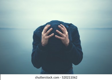 desperate man holding head with hands