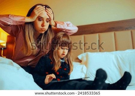 
Desperate Mom Supervising What her Kid Watches Online. Worried mother checking out the internet activity of her little one
