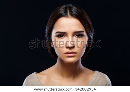 In desperate need. Close up of poor sad depressed young woman  begging for help and going to cry while standing isolate on black background