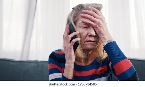 Desperate Old Woman Having Phone Conversation With Tears. High Quality Photo