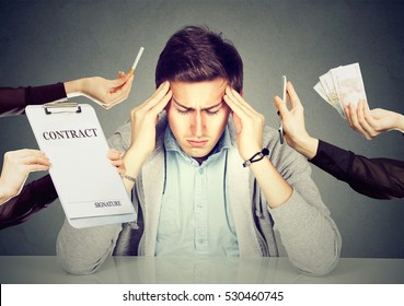 Desperate Sad Young Man Leaning On A Desk. Stressed Guy Overwhelmed By Things Errands Should Be Done. Human Face Expression Emotions 