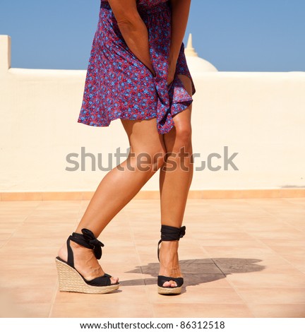 desperate - tanned female legs in high heels, crossed