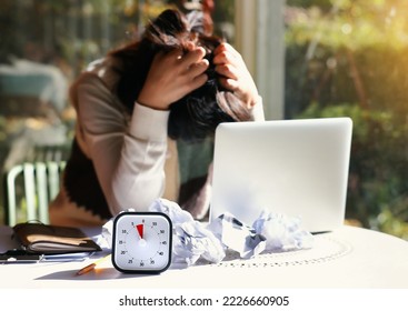 Desperate woman with an impending deadline lying face down on the table - Shutterstock ID 2226660905