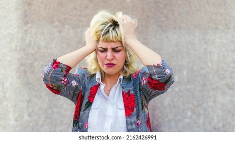 Desperate woman pulling out her hair, stress and overwhelm in the world of work, overwhelmed woman pulling her hair out