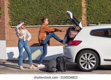 Desperate Young Couple Trying To Get All The Suitcases In The Car To Go On A Road Trip For Spring Break