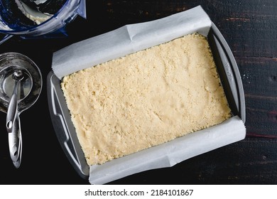 Dessert Bar Crust Pressed Into A Metal Baking Pan: Unbaked Pastry Crust In A Parchment Paper Lined Brownie Pan